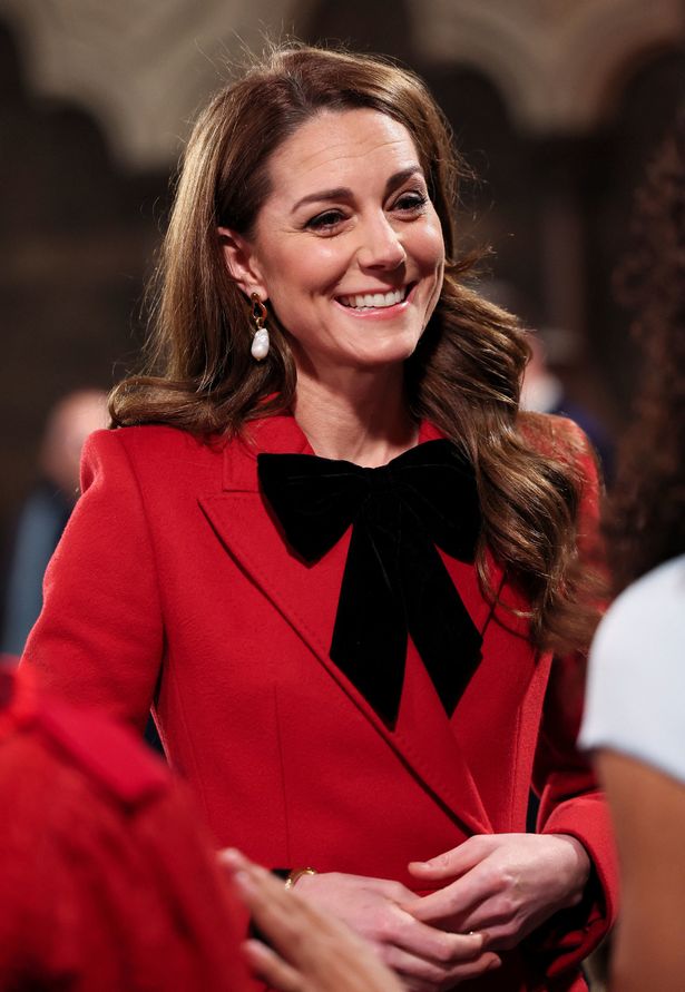 Kate in a red maxi coat by Alexander McQueen coat