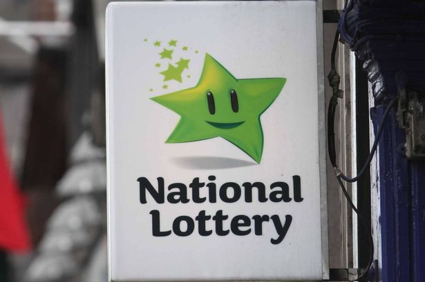 A sweep Tickets sign above a National Lottery sign on Dame Street