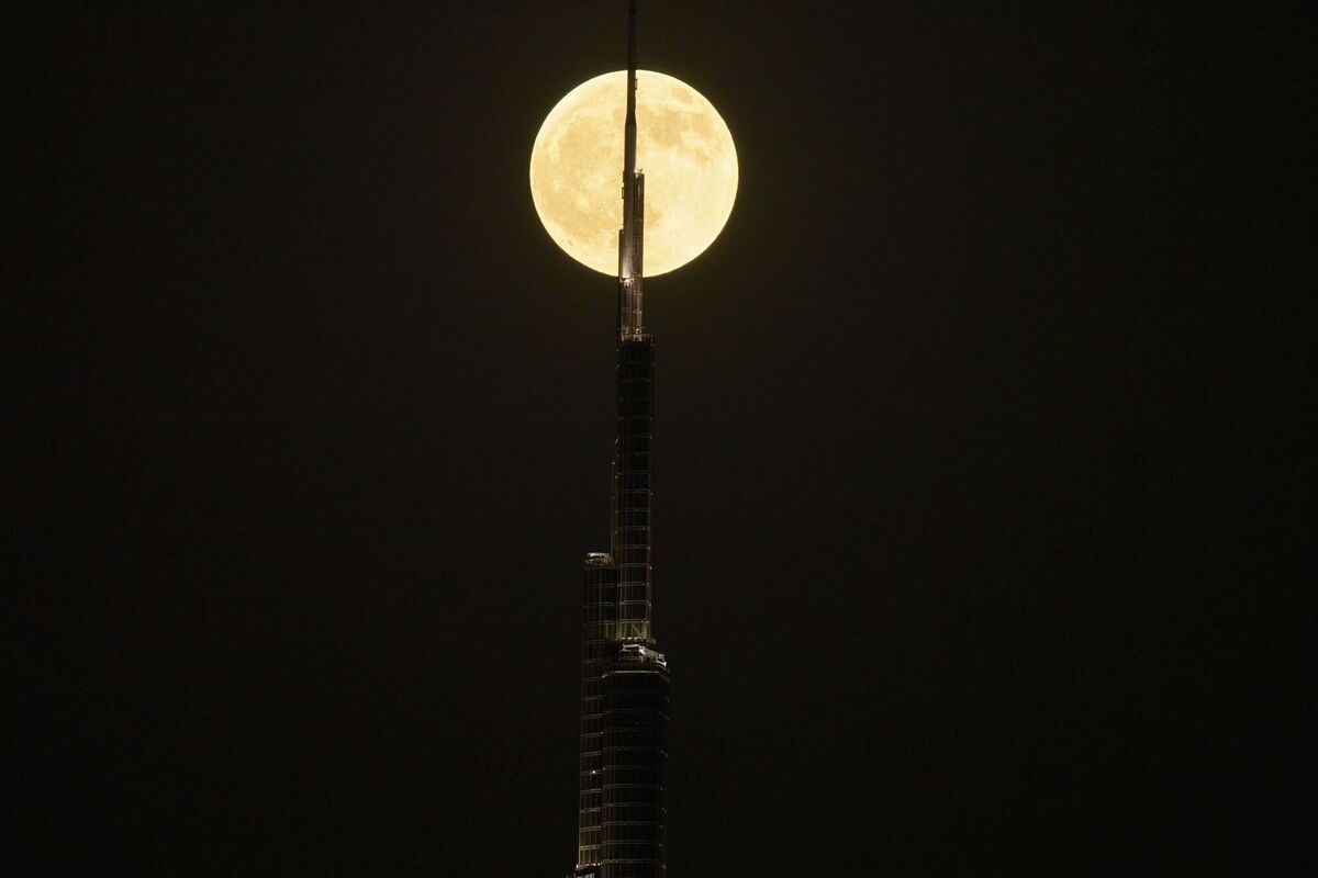 The moon is seen behind the Burj Khalifa in Dubai, United Arab Emirates. Picture: Fatima Shbair/AP The moon is seen behind the Burj Khalifa in Dubai, United Arab Emirates. Picture: Fatima Shbair/AP
