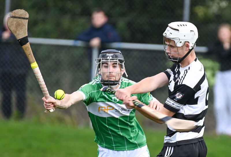 Midleton's Carthaigh Cronin clears his lines as Aghabullogue's James Lane closes in. Picture: David Keane.  Midleton's Carthaigh Cronin clears his lines as Aghabullogue's James Lane closes in. Picture: David Keane.