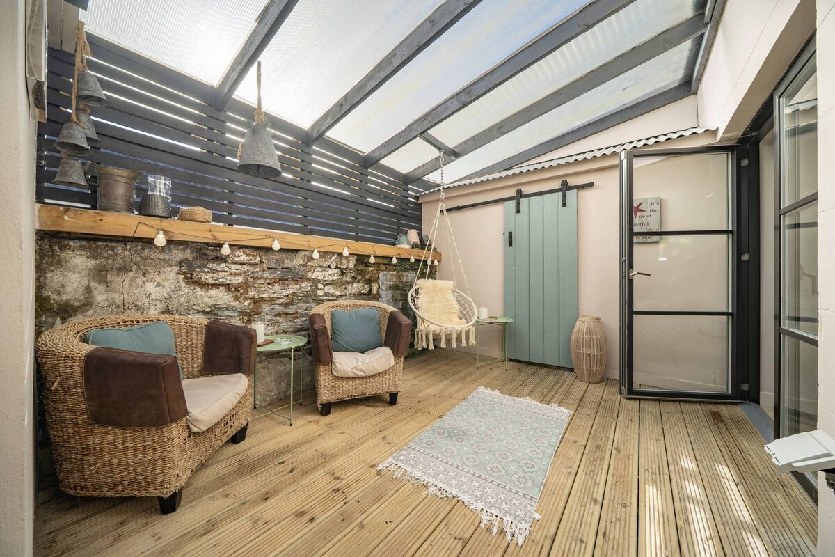 Sliding barn door to storage space in the covered courtyard