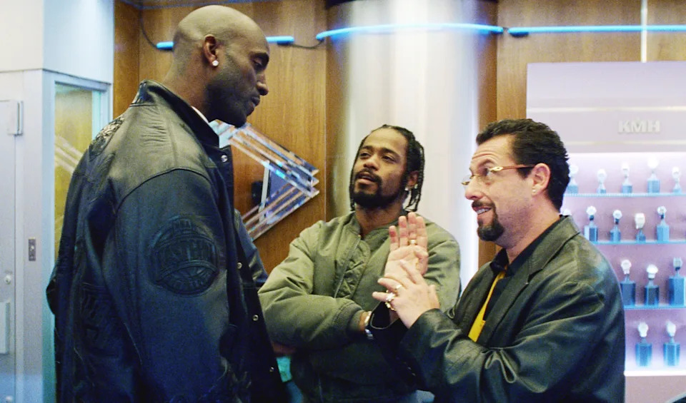 Three men in casual jackets converse in a store setting featured in a TV and movies article