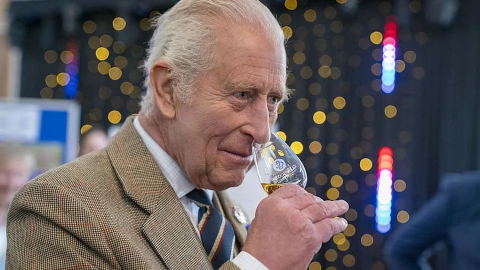 King Charles with a whisky glass