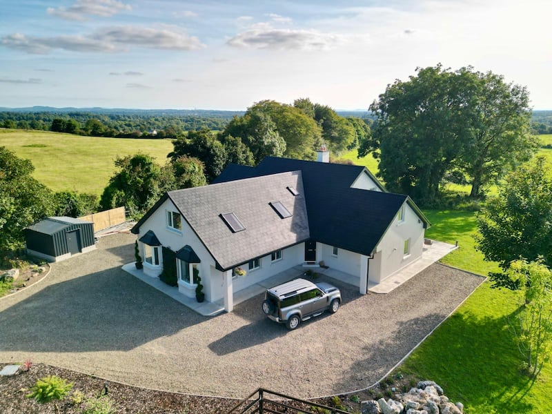 The property stands on 0.9 acres with ancient oak trees