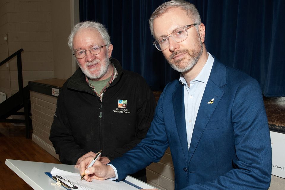 Roderic O'Gorman TD pictured with Senator Malcolm Noonan signing the petition during the Save Our Lady's Island campaign on Saturday. Pic: Jim Campbell