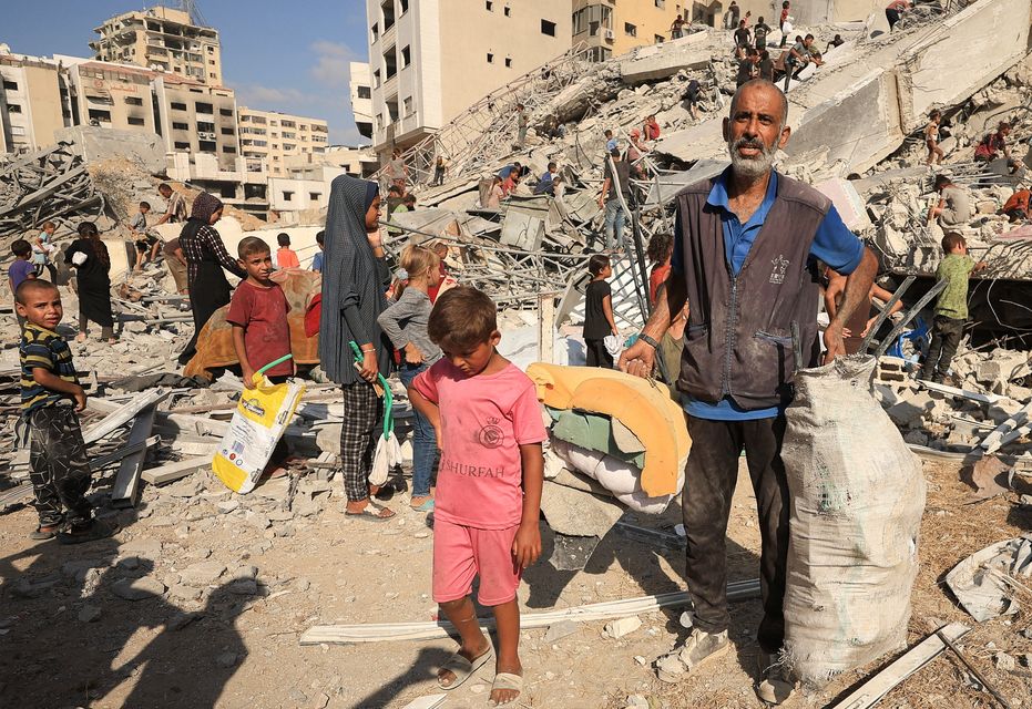 Palestinians gather their things after yesterday's Israeli air strike. Photo: Reuters
