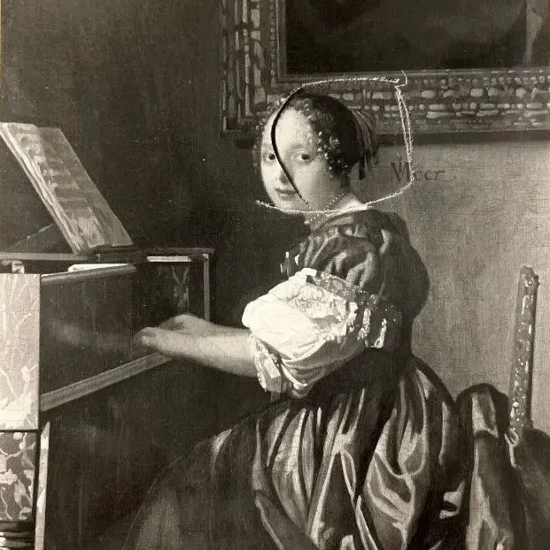 In the photo marks appear around the woman's head, while a slash runs from her hair to the bottom of her face