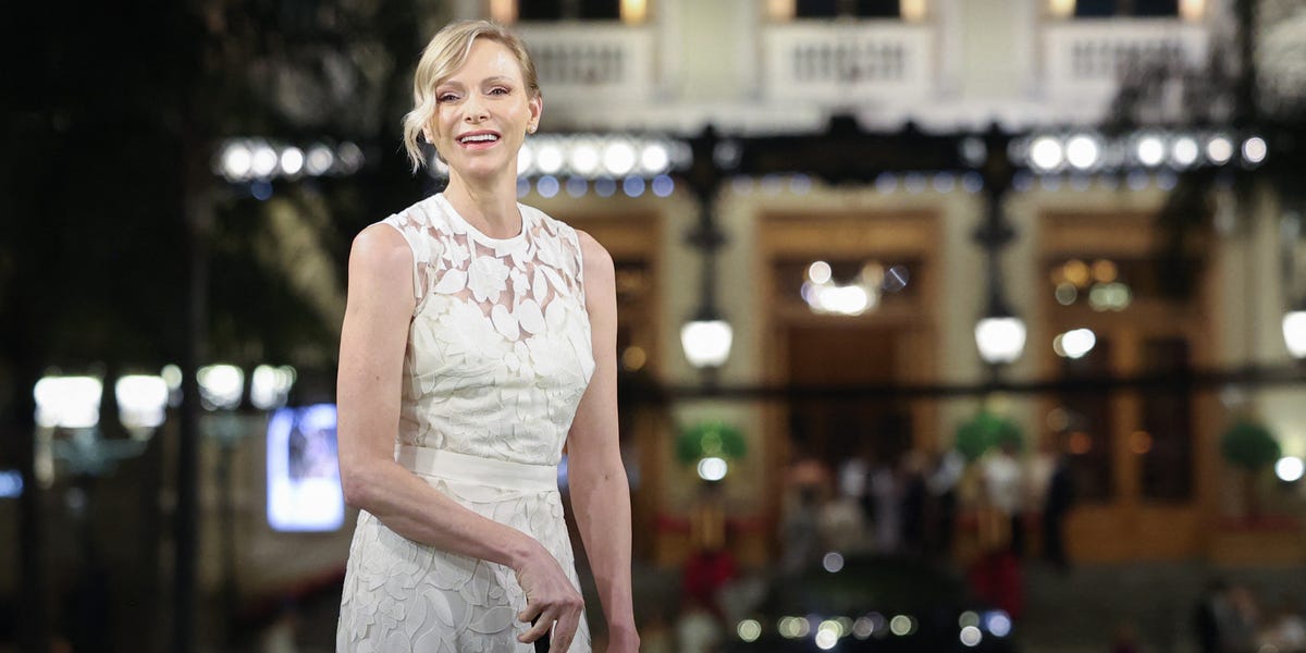 Princess Charlene of Monaco Golfs in White Lace Dress