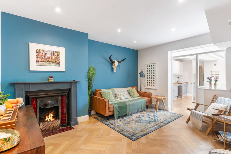 The living room, with open fire and glass door to kitchen/diner