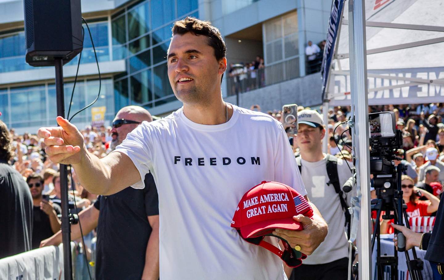 Charlie Kirk hands out hats before speaking at Utah Valley University in Orem, Utah, Wednesday, September 10, 2025.
