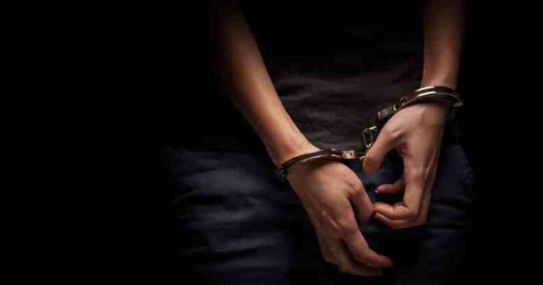 A teenager hands in handcuffs