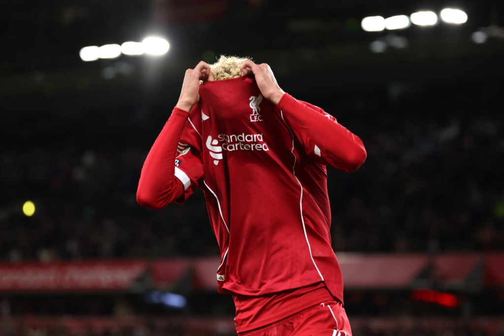 Hugo Ekitike of Liverpool celebrates scoring his team's second goal by removing his match shirt and subsequently receives a second yellow card from Referee Thomas Bramall (not pictured) to be sent off during the Carabao Cup Third Round match between Liverpool and Southampton at Anfield