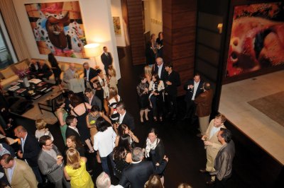 People mingle at a collector's home during a cocktail reception. 