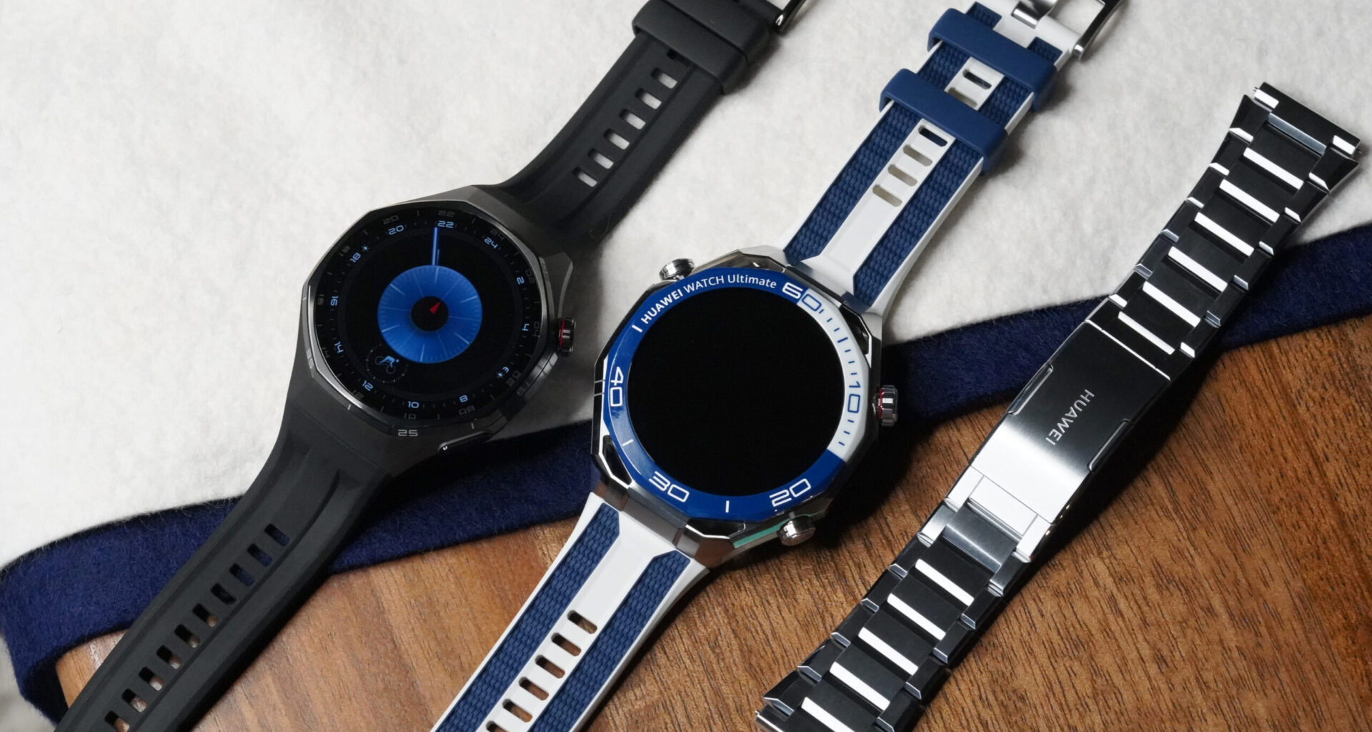 A Huawei Watch GT 6 Pro rests next to a Huawei Watch Ultimate 2