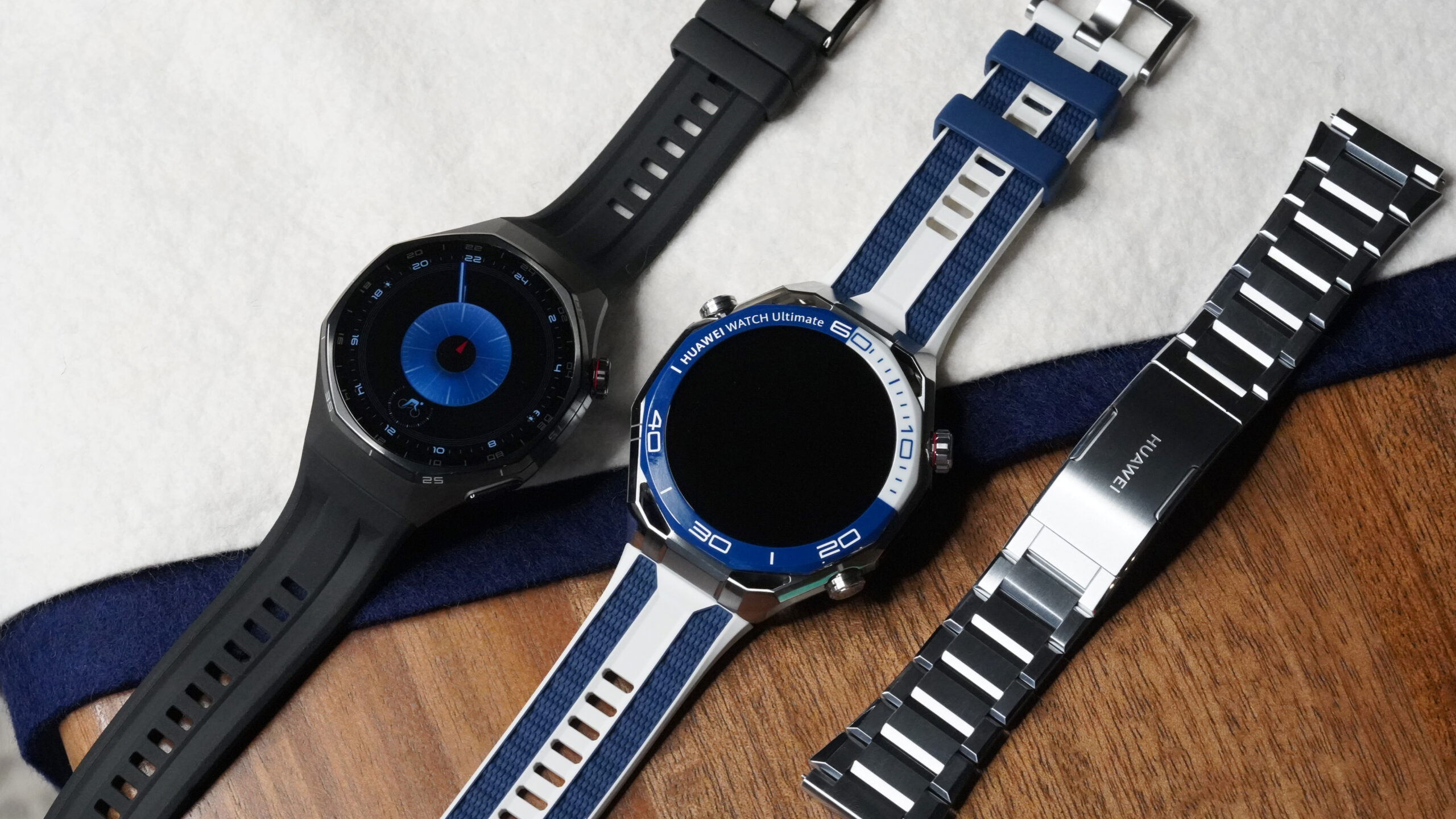 A Huawei Watch GT 6 Pro rests next to a Huawei Watch Ultimate 2