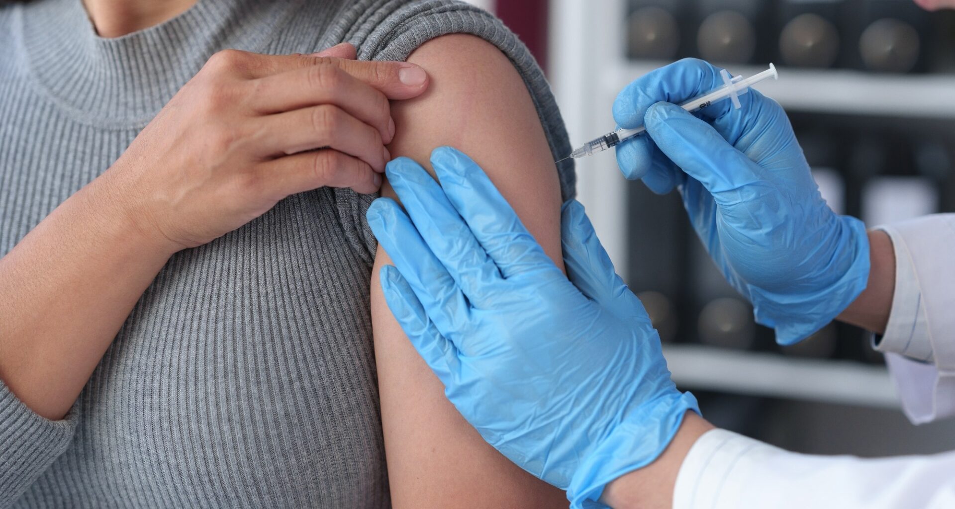 woman receives flu vaccine at hospital