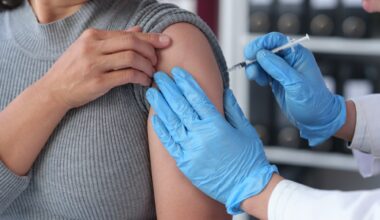 woman receives flu vaccine at hospital