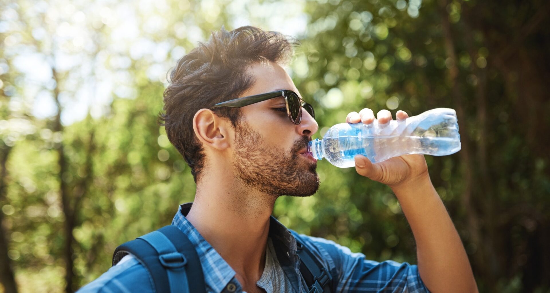 young man stopping for a drink of water
