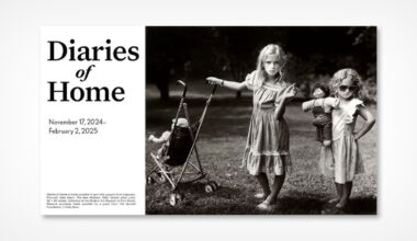 Two young girls in vintage dresses stand outdoors. One pushes a doll in a stroller, while the other holds a doll and wears sunglasses. The image promotes an exhibit titled "Diaries of Home" running from November 17, 2024, to February 2, 2025.
