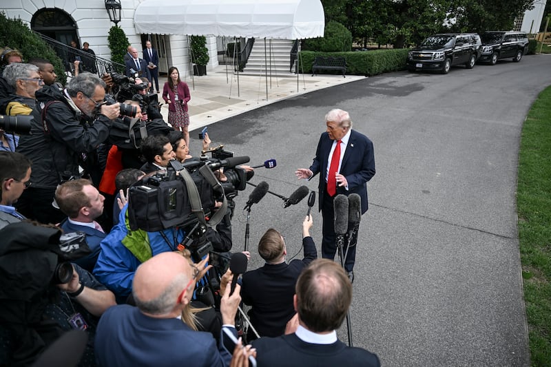 President Donald Trump speaks to reporters as he departed the White House, bound for a trip to Britain. Photograph: Kenny Holston/The New York Times
                      