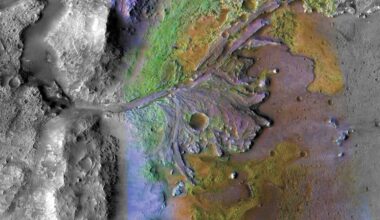 Jezero crater: View from above of terrain with a meandering river delta and small craters in grays, blues and greens.
