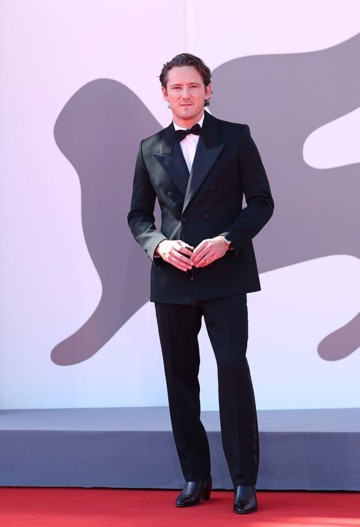 Lewis Pullman attends "The Testament Of Ann Lee" Venice Film Festival premiere Saint Laurent tuxedo, Lewis Pullman Venice Film Festival 2025, Kaia Gerber Givenchy, Saint Laurent, The Testament Of Ann Lee