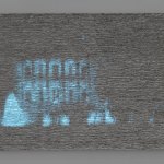 An abstract painting that is mostly gray and made of dozens of layers of oil paint has a grainy image of the White House projected on it.