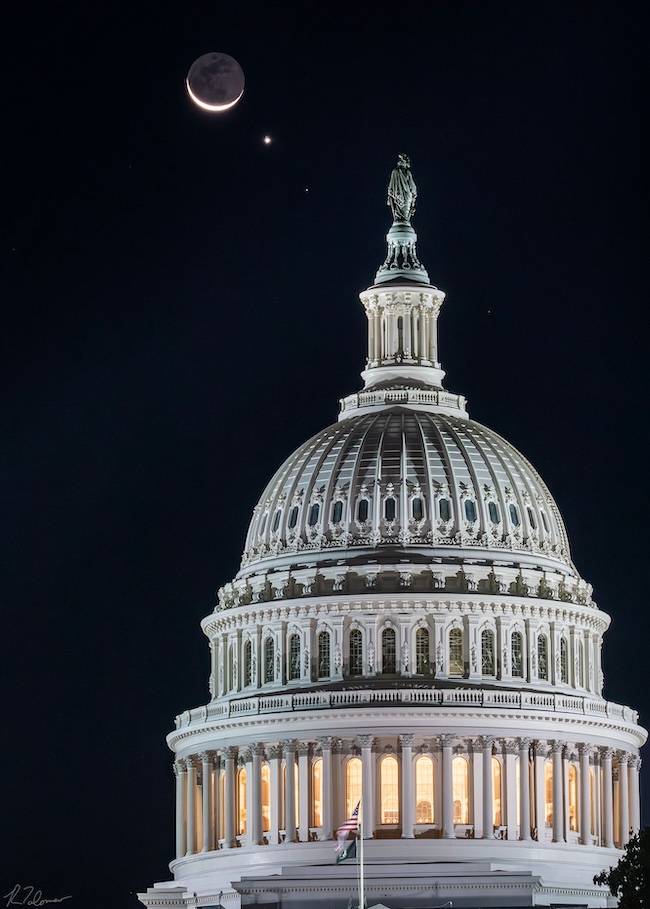 Dome of the US Capitol building with the moon, Venus and Regulus in the dark sky behind it.