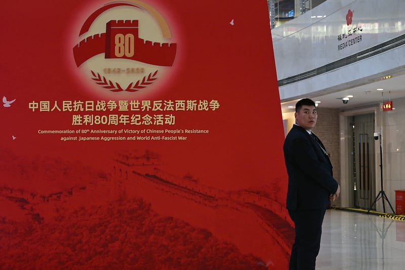 A security official in Beijing keeps watch beside signage commemorating the 80th anniversary of the victory over Japan and the end of the second World War. Photograph:  Jade Gao/AFP via Getty Images          