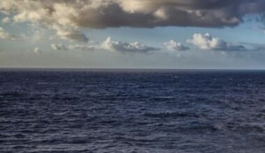 dark Pacific Ocean, with clouds above