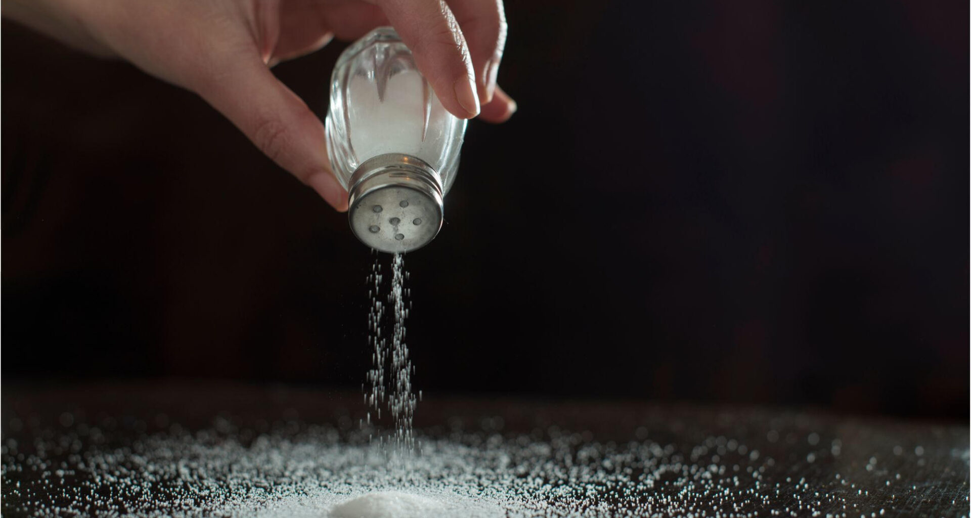 Sprinkling Salt on Table Concept