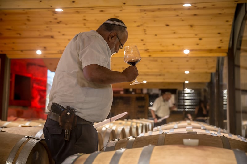 Wine maker and settler Eliav Hillel (67) always carries a gun in a holster for 'self-defence'. Photograph: Sally Hayden