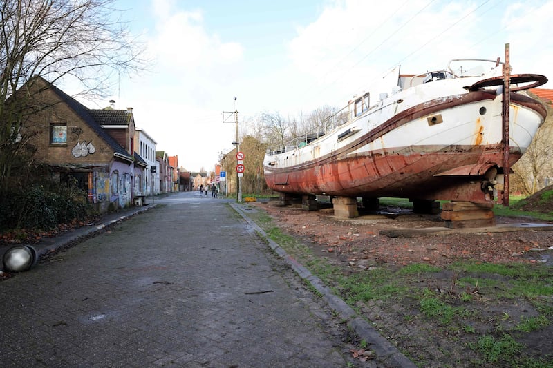 People walking past abandoned in Doel near the city of Antwerp. Photograph: François Walschaerts/AFP via Getty Images