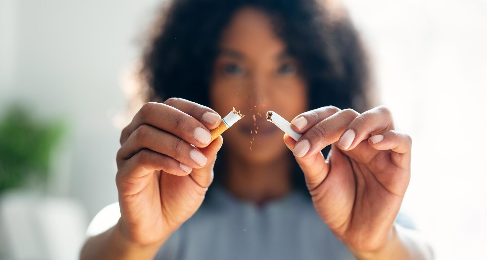 Woman Breaking Cigarette in Half