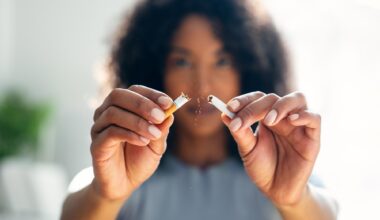 Woman Breaking Cigarette in Half