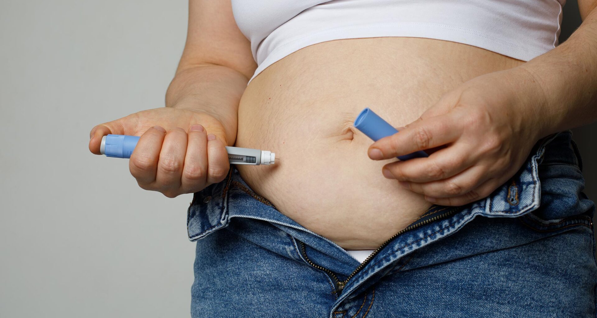 Woman injecting Semaglutide Ozempic Stomach