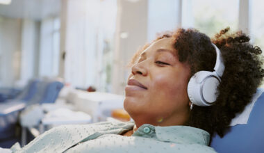 Woman listening to music while waiting for medical treatment.