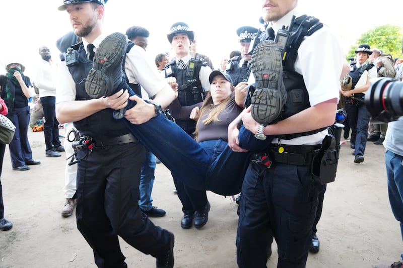 Police officers remove a protester. Photograph: Jeff Moore/PA Wire