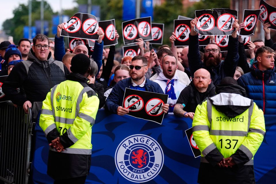 Rangers fans hold signs during a protest organised by Rangers supporters' group The Union Bears against Rangers head coach Russell Martin and chief executive Patrick Stewart