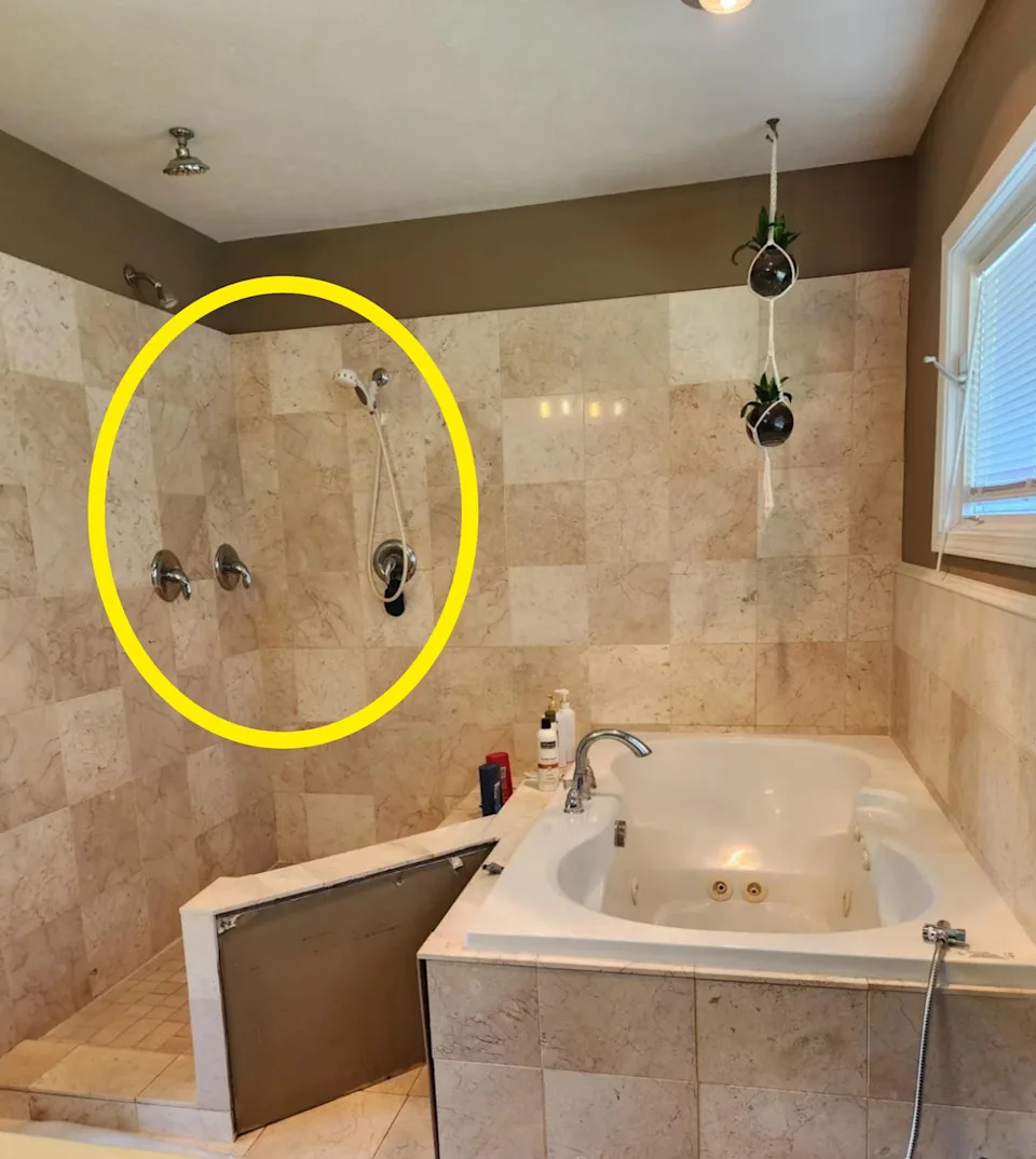 Bathroom with beige tile features an open-wall shower