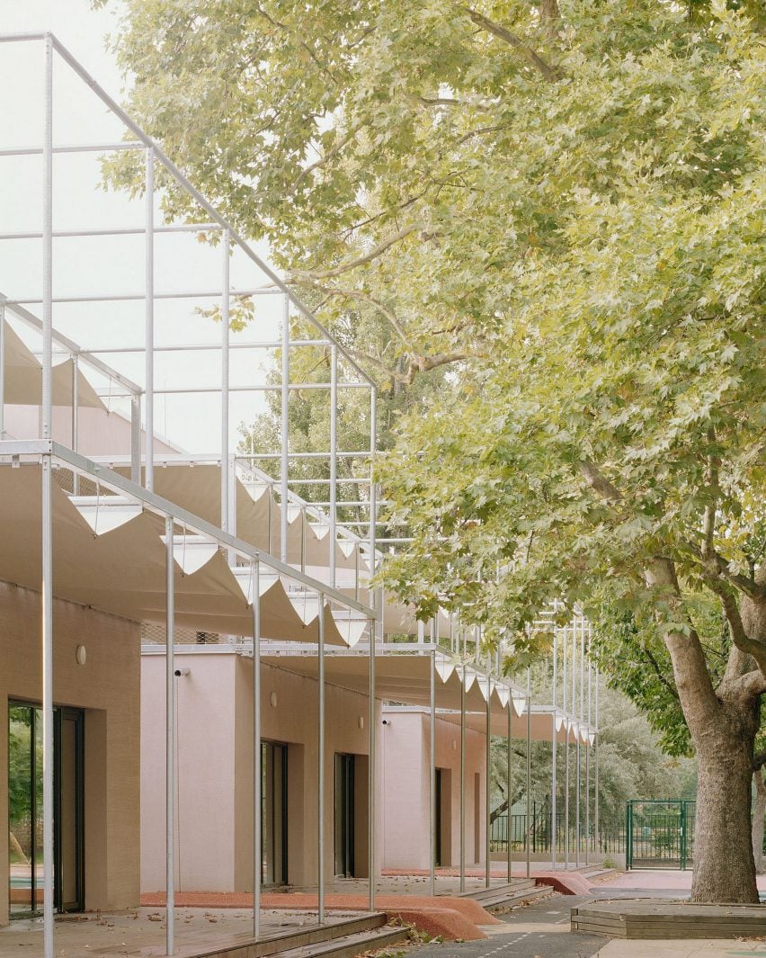 Metal canopies line nursery by Archikon