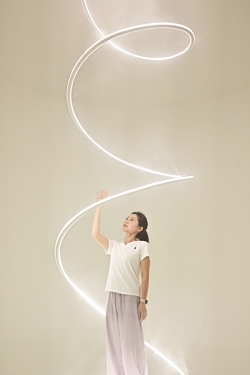karolina halatek presents large-scale spiral installation of mist and light for lancôme