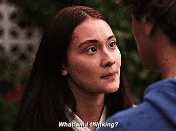 A person with long hair looks up at another person. The words "What am I thinking?" are visible at the bottom