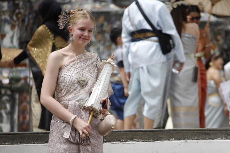 A tourist wears traditional Thai attire during her visit to Wat Arun, also known as the Temple of Dawn, on July 11, 2025. (Photo: Pattarapong Chatpattarasill)