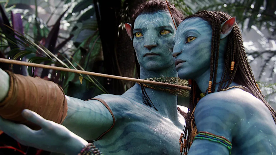 Two Na'vi characters with bows in a lush alien jungle setting, from a well-known sci-fi movie