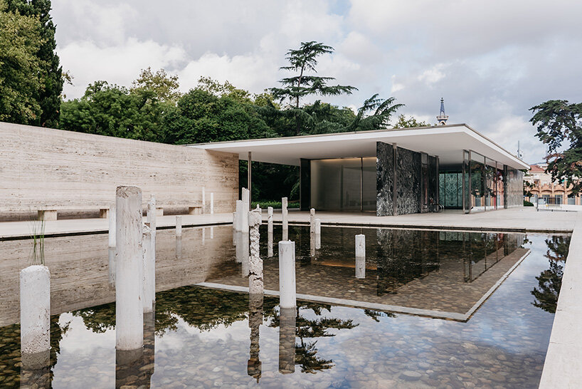 concrete sculptures surface from the pond of mies van der rohe's barcelona pavilion