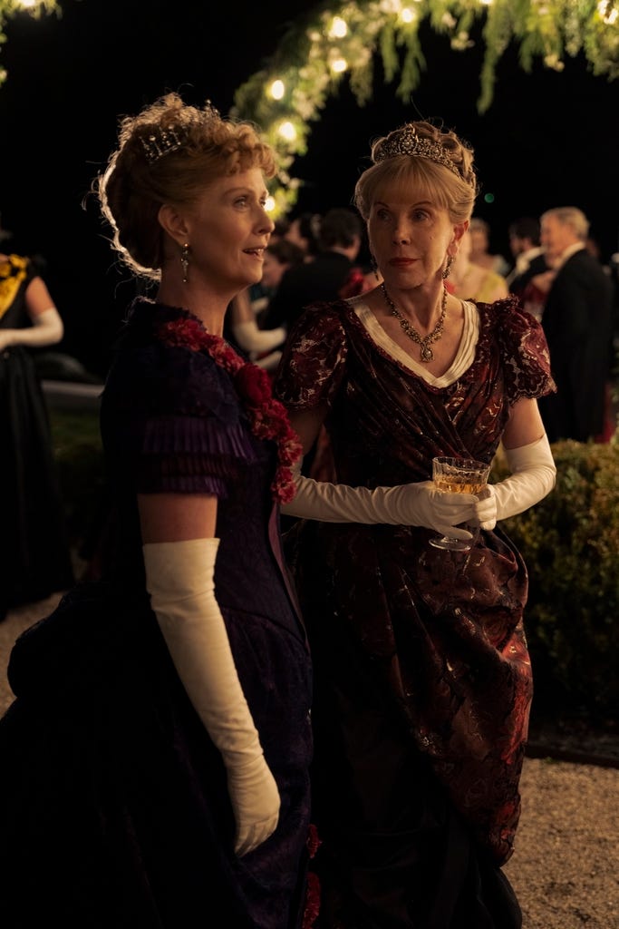 Cynthia Nixon and Christine Baranski in sumptuous gowns, tiaras and long white gloves in an outdoor party scene from the gilded age cynthia nixon and christine baranski in sumptuous gowns, tiaras and long white gloves in an outdoor party scene from the gilded age