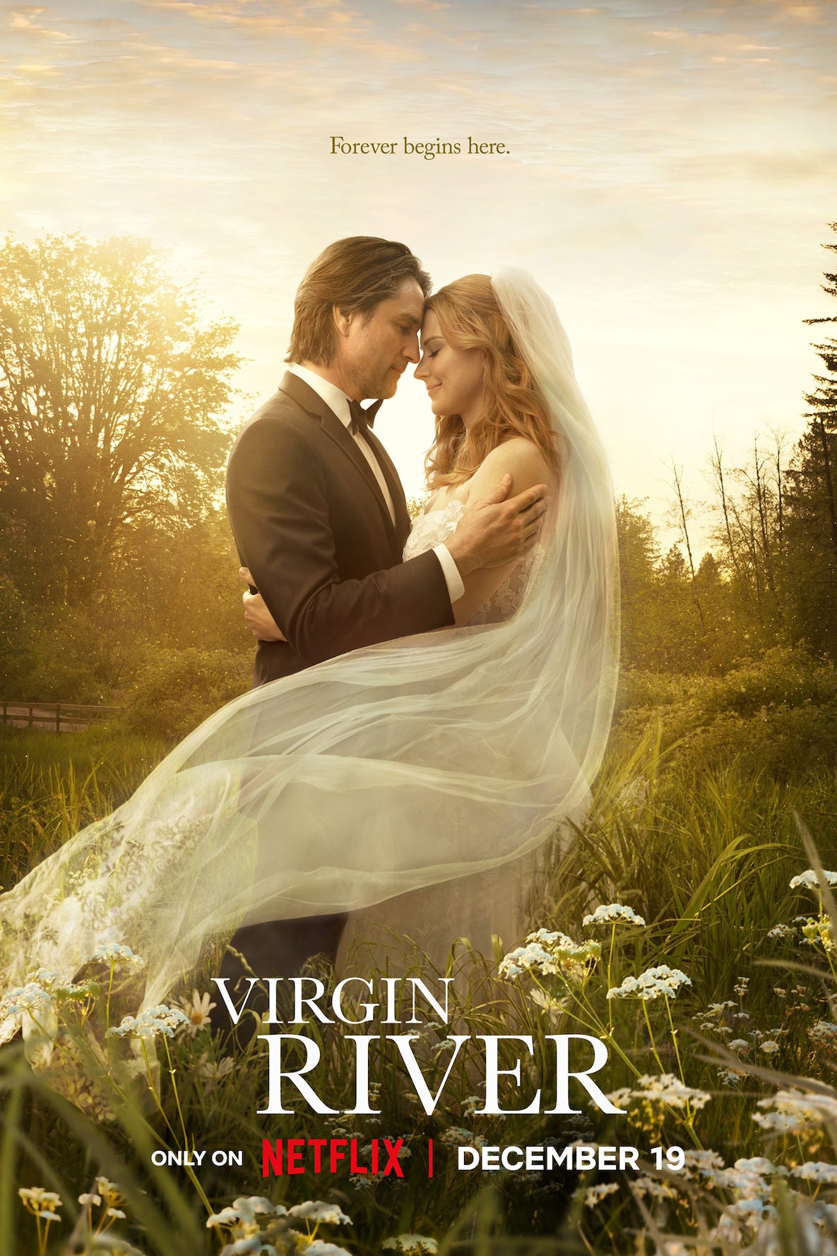 Promotional poster for the show Virgin River featuring a romantic couple in a tux and wedding dress embracing in a scenic field with wildflowers promotional poster for the show virgin river featuring a romantic couple in a tux and wedding dress embracing in a scenic field with wildflowers