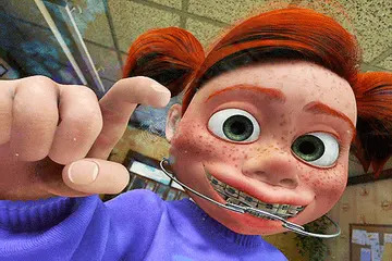 Animated character with braces and freckles, wearing a headgear, smiles and points playfully towards the viewer in a classroom setting