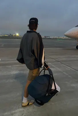 Sharing a carousel on Instagram this week, Millie posted a bunch of photos of herself and Jake, including one that showed Jake holding their little girl in her carrier while walking toward a plane.